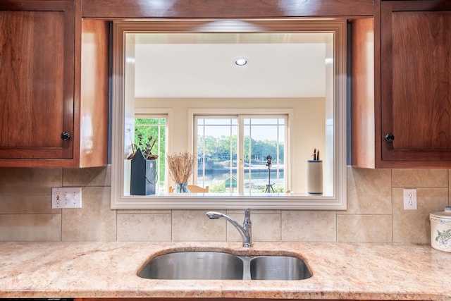 23 Hefflon Farm Rd, Old Lyme, CT 06371 - kitchen featuring a sink, tasteful backsplash, brown cabinets, and light stone counters