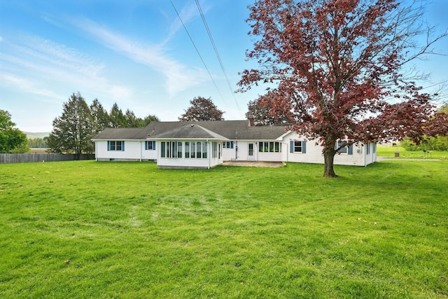 back of property featuring a sunroom and a patio area