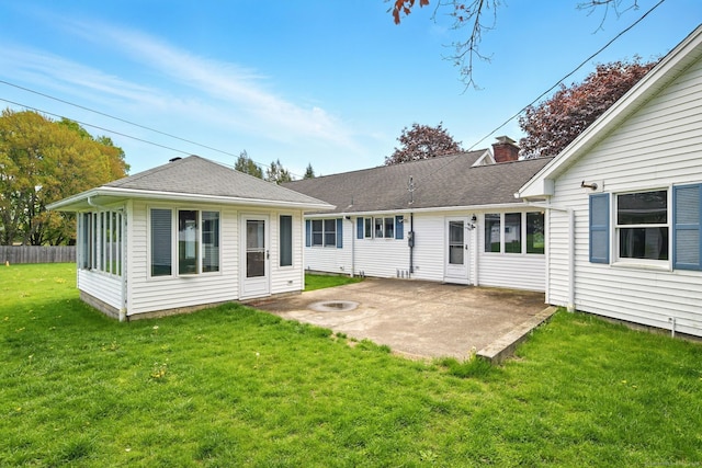 back of property featuring a patio area, a chimney, and a shingled roof