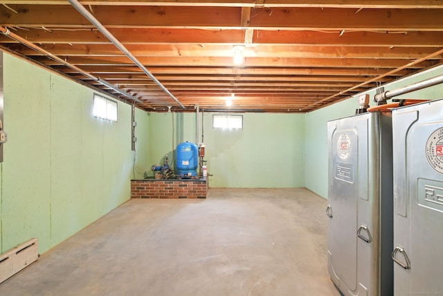 below grade area with baseboard heating and a water pressure tank