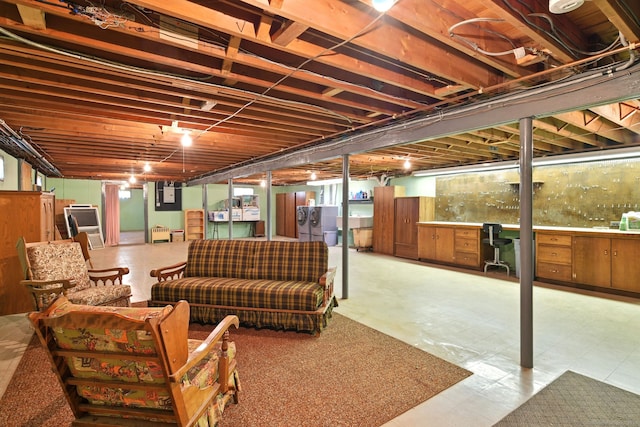 finished below grade area featuring an office area, washing machine and clothes dryer, and tile patterned floors