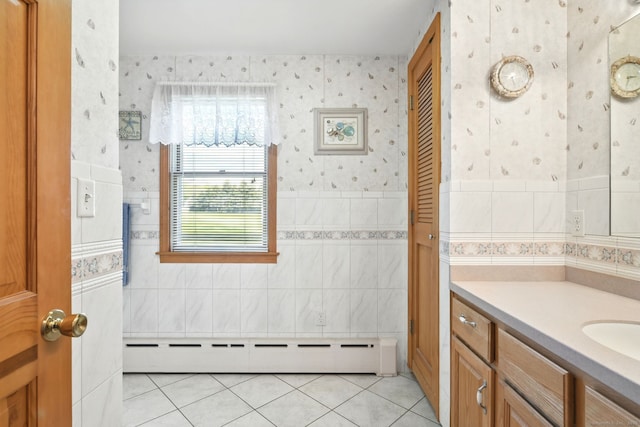 bathroom featuring a baseboard radiator, wallpapered walls, tile patterned floors, vanity, and tile walls