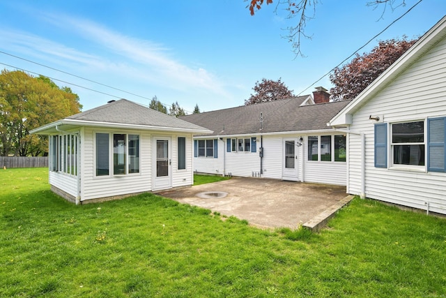 rear view of property featuring a patio, a chimney, and a shingled roof