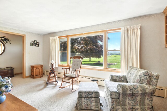 living area with carpet flooring and a baseboard heating unit