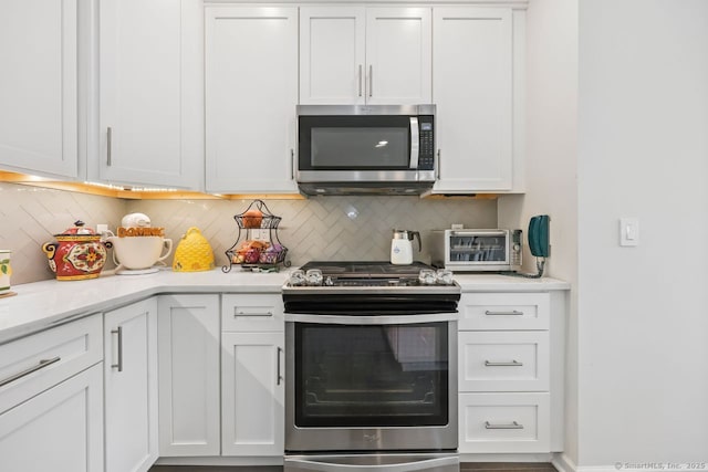 1022 Country View Rd Unit 1022, Danbury, CT 06810 - kitchen with stainless steel appliances, tasteful backsplash, light countertops, and white cabinets