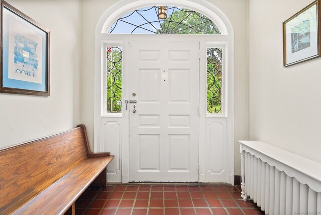 44 Walbridge Rd, West Hartford, CT 06119 - foyer featuring radiator heating unit, dark tile patterned floors, and healthy amount of natural light