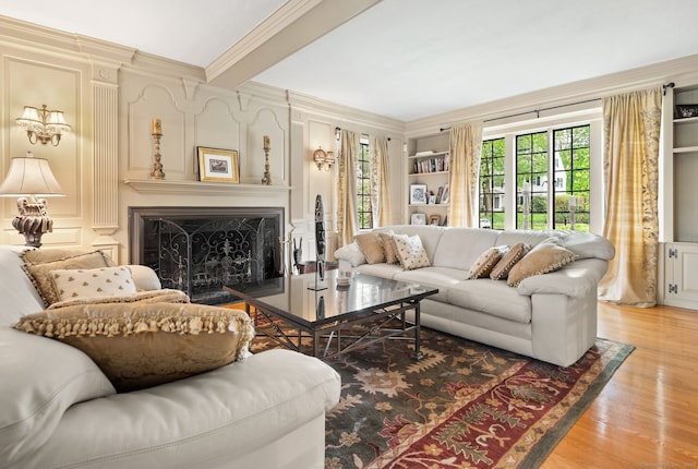 44 Walbridge Rd, West Hartford, CT 06119 - living area featuring crown molding, light wood-style floors, a fireplace, plenty of natural light, and a decorative wall