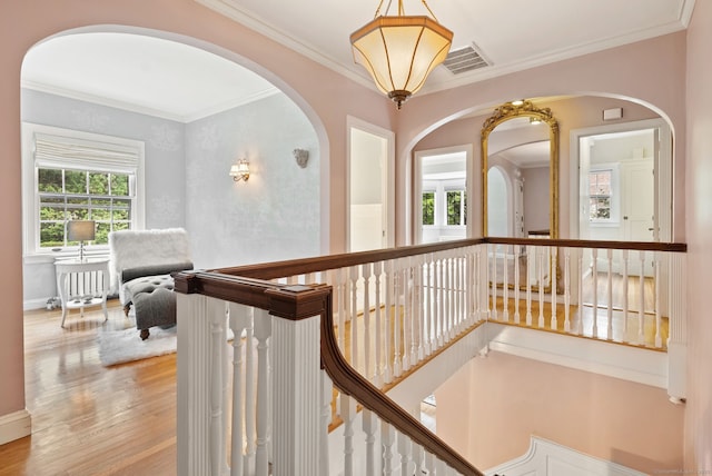 44 Walbridge Rd, West Hartford, CT 06119 - hallway featuring ornamental molding, wood finished floors, an upstairs landing, arched walkways, and radiator heating unit