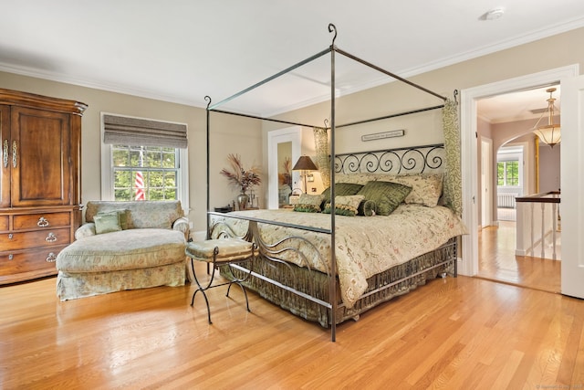 44 Walbridge Rd, West Hartford, CT 06119 - bedroom featuring crown molding, light wood-style flooring, and arched walkways