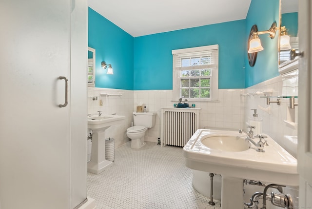 44 Walbridge Rd, West Hartford, CT 06119 - full bathroom with radiator heating unit, tile walls, wainscoting, toilet, and tile patterned flooring