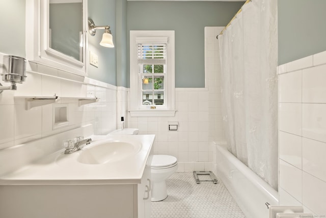 44 Walbridge Rd, West Hartford, CT 06119 - bathroom with tile walls, tile patterned floors, wainscoting, toilet, and shower / tub combo with curtain