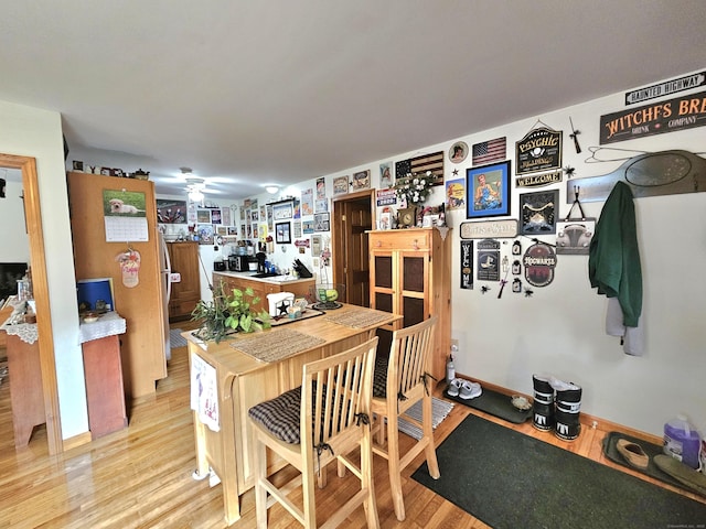69 Elmdale Rd, Canterbury, CT 06331 - dining space with light wood-style flooring, a ceiling fan, and baseboards