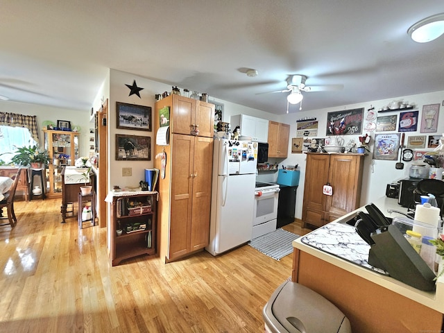 69 Elmdale Rd, Canterbury, CT 06331 - kitchen with white appliances, a ceiling fan, light wood-style floors, and brown cabinetry