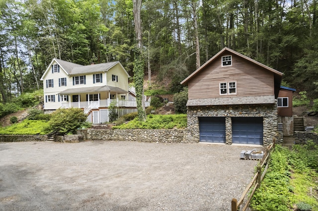 18 Brookside Trl, Monroe, CT 06468 - view of front of home with stone siding, driveway, and a garage