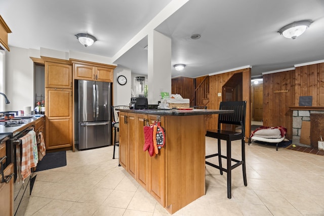 18 Brookside Trl, Monroe, CT 06468 - kitchen with freestanding refrigerator, stove, a kitchen breakfast bar, light tile patterned flooring, and wood walls