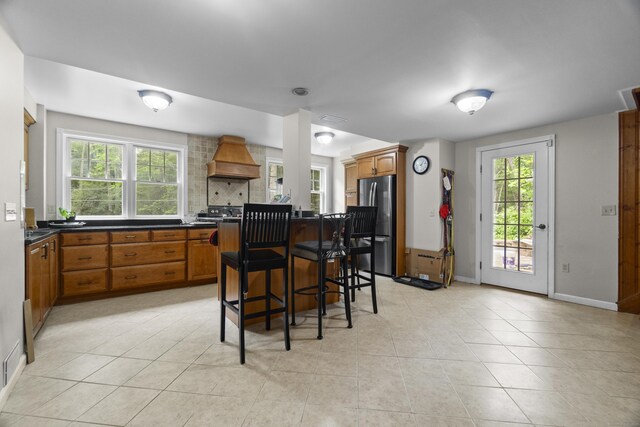 18 Brookside Trl, Monroe, CT 06468 - kitchen with freestanding refrigerator, dark countertops, brown cabinets, and a kitchen breakfast bar