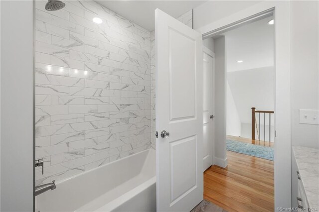 full bath featuring wood finished floors and shower / bath combination