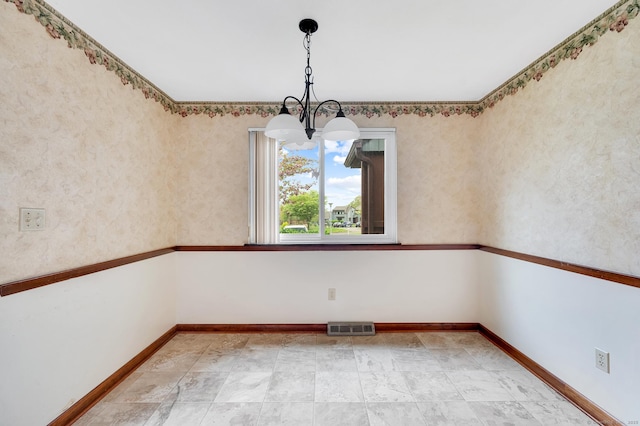 unfurnished dining area featuring a notable chandelier, baseboards, and visible vents