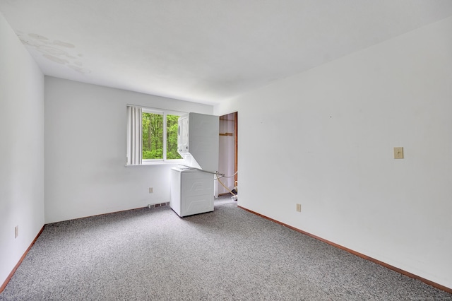 empty room with baseboards and carpet flooring
