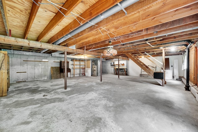 unfinished basement featuring stairway