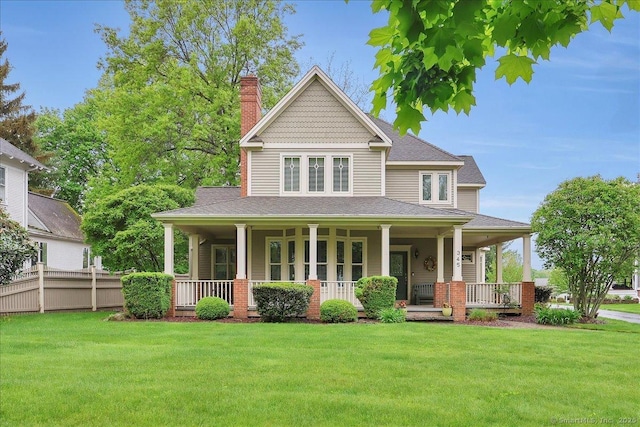 farmhouse inspired home featuring a chimney, a porch, and a front lawn