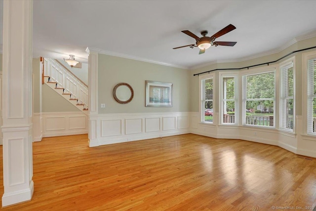 spare room with crown molding, light wood-type flooring, and ceiling fan