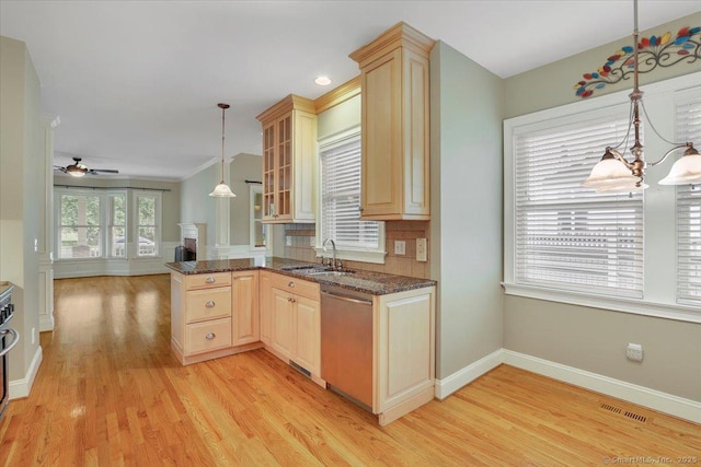 kitchen with a sink, light wood-type flooring, visible vents, stainless steel dishwasher, and light brown cabinets