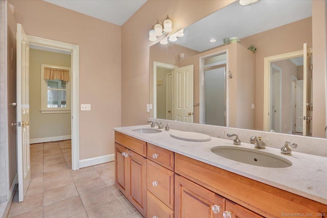 full bathroom featuring baseboards, tile patterned floors, double vanity, and a sink