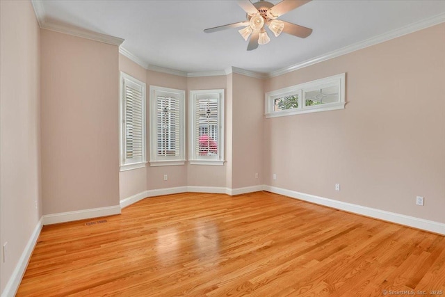 spare room with light wood finished floors, baseboards, and ceiling fan