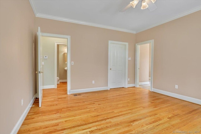 unfurnished bedroom featuring crown molding, baseboards, light wood finished floors, and visible vents