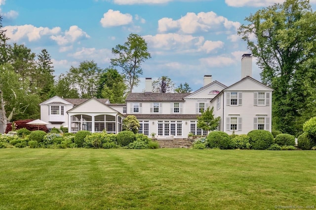 3113 Bronson Rd, Fairfield, CT 06824 - rear view of house with a sunroom and a yard