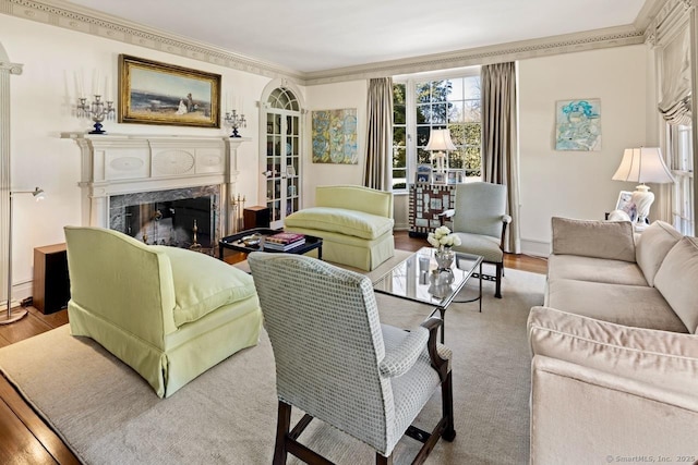 3113 Bronson Rd, Fairfield, CT 06824 - living area featuring wood finished floors, a high end fireplace, crown molding, and baseboards