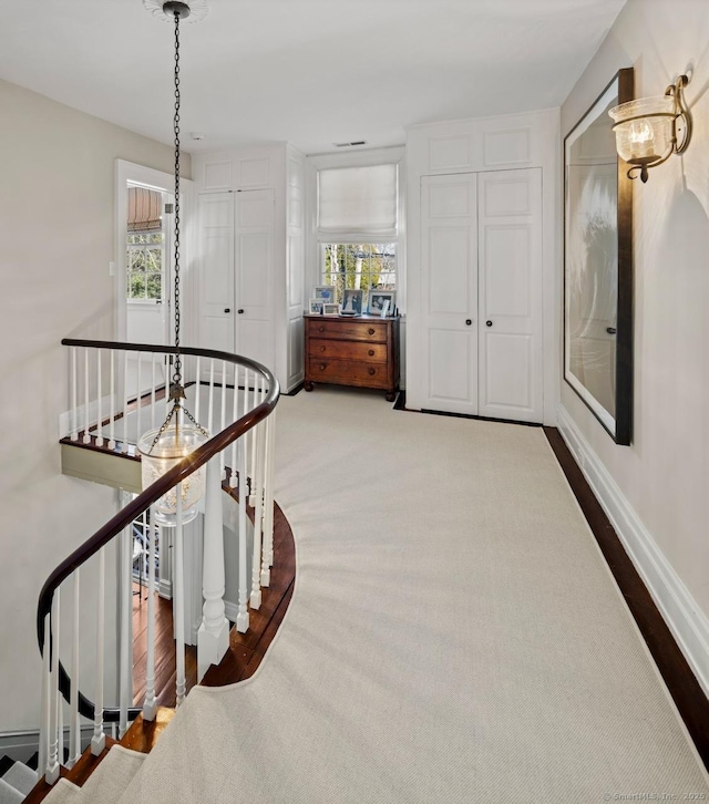 3113 Bronson Rd, Fairfield, CT 06824 - corridor featuring an upstairs landing, plenty of natural light, baseboards, and wood finished floors