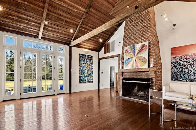 3113 Bronson Rd, Fairfield, CT 06824 - living room with wood ceiling, high vaulted ceiling, wood-type flooring, a brick fireplace, and french doors