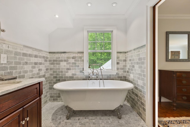 9 Brick School Dr, Redding, CT 06896 - bathroom featuring tile walls, a freestanding tub, vanity, a wainscoted wall, and crown molding