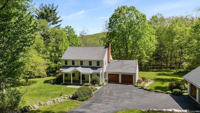 9 Brick School Dr, Redding, CT 06896 - colonial home with a porch, driveway, a front lawn, and a chimney