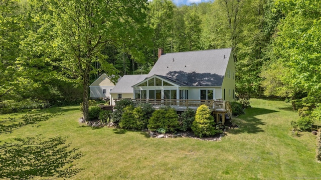 9 Brick School Dr, Redding, CT 06896 - rear view of house with a chimney, a wooded view, a yard, a wooden deck, and a shingled roof