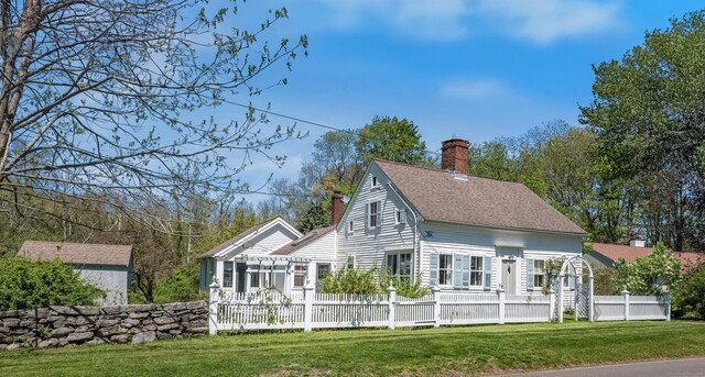 76 Neck Rd, Madison, CT 06443 - view of side of home featuring a chimney and roof with shingles