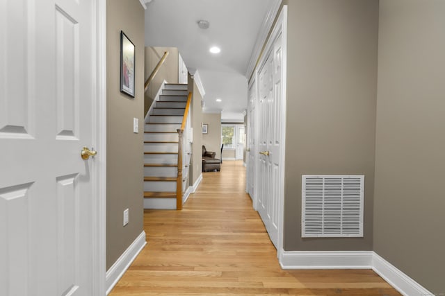 corridor with recessed lighting, baseboards, visible vents, stairs, and light wood-type flooring