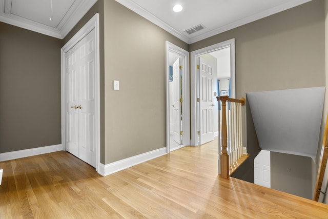 corridor featuring attic access, an upstairs landing, visible vents, light wood finished floors, and baseboards