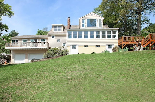 231 Lake Shore Dr, East Haddam, CT 06415 - rear view of house with a wooden deck, a chimney, a yard, and an attached garage