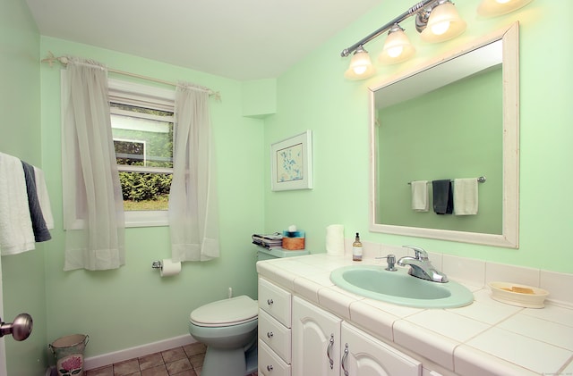 231 Lake Shore Dr, East Haddam, CT 06415 - bathroom with vanity, toilet, baseboards, and tile patterned floors