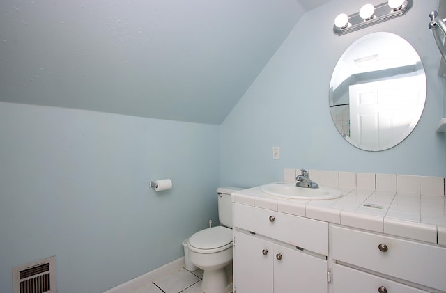231 Lake Shore Dr, East Haddam, CT 06415 - bathroom with vaulted ceiling, toilet, vanity, tile patterned floors, and heating unit
