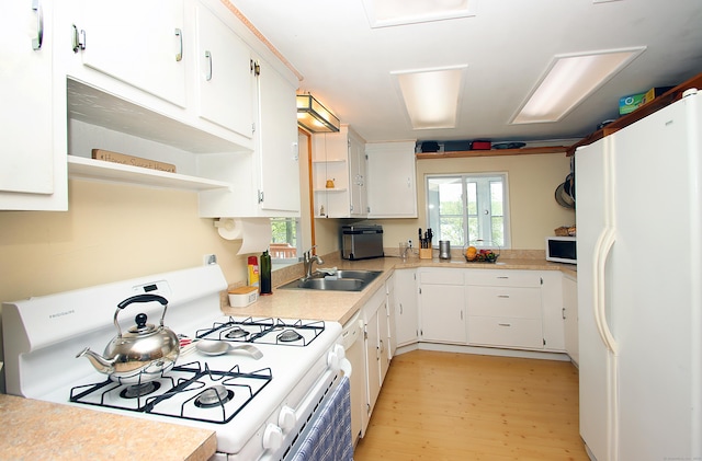 231 Lake Shore Dr, East Haddam, CT 06415 - kitchen with white appliances, a sink, light wood-type flooring, and white cabinets