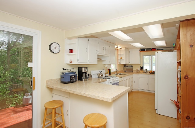 231 Lake Shore Dr, East Haddam, CT 06415 - kitchen with white appliances, a sink, open shelves, a peninsula, and light countertops