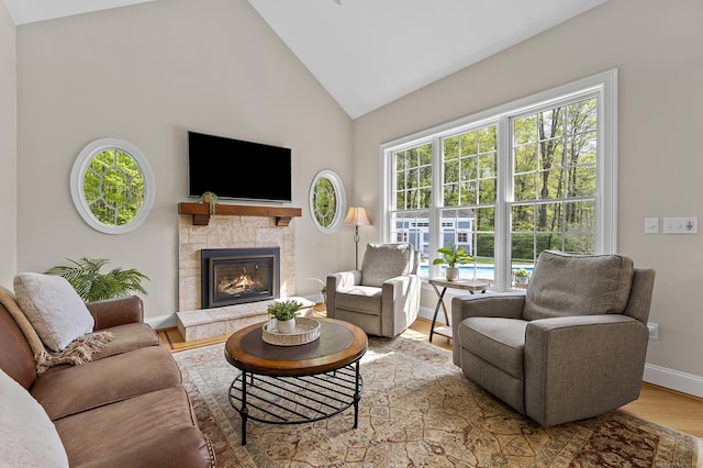 15 Hickory Hill Rd, Avon, CT 06001 - living area featuring a tiled fireplace, wood finished floors, baseboards, and high vaulted ceiling