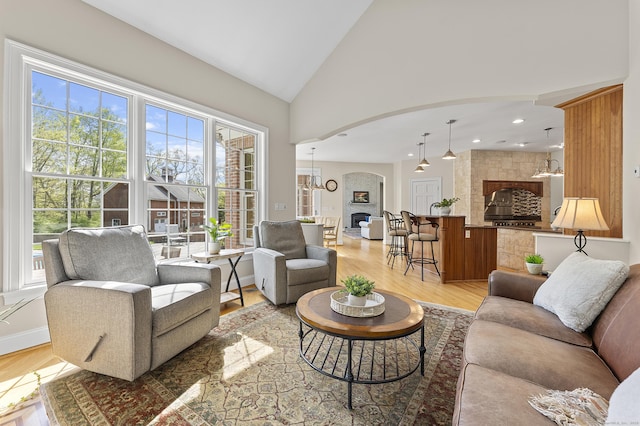15 Hickory Hill Rd, Avon, CT 06001 - living room featuring arched walkways, recessed lighting, light wood finished floors, and high vaulted ceiling