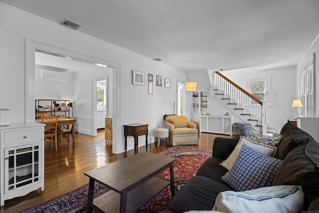 living room with stairs, radiator, plenty of natural light, and visible vents
