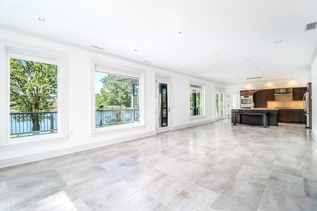 13 Kellogg St, Brookfield, CT 06804 - unfurnished living room featuring plenty of natural light, light tile patterned flooring, and baseboards