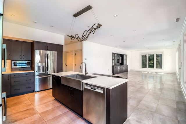 13 Kellogg St, Brookfield, CT 06804 - kitchen featuring stainless steel appliances, a sink, light tile patterned floors, and an island with sink